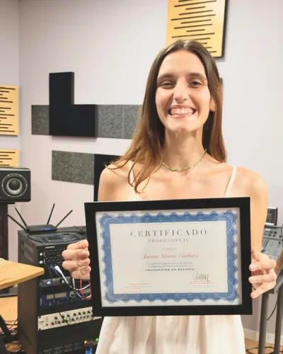 Student holding her Professional Certificate in Studio Production