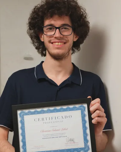 Student holding his Professional Certificate in Studio Production